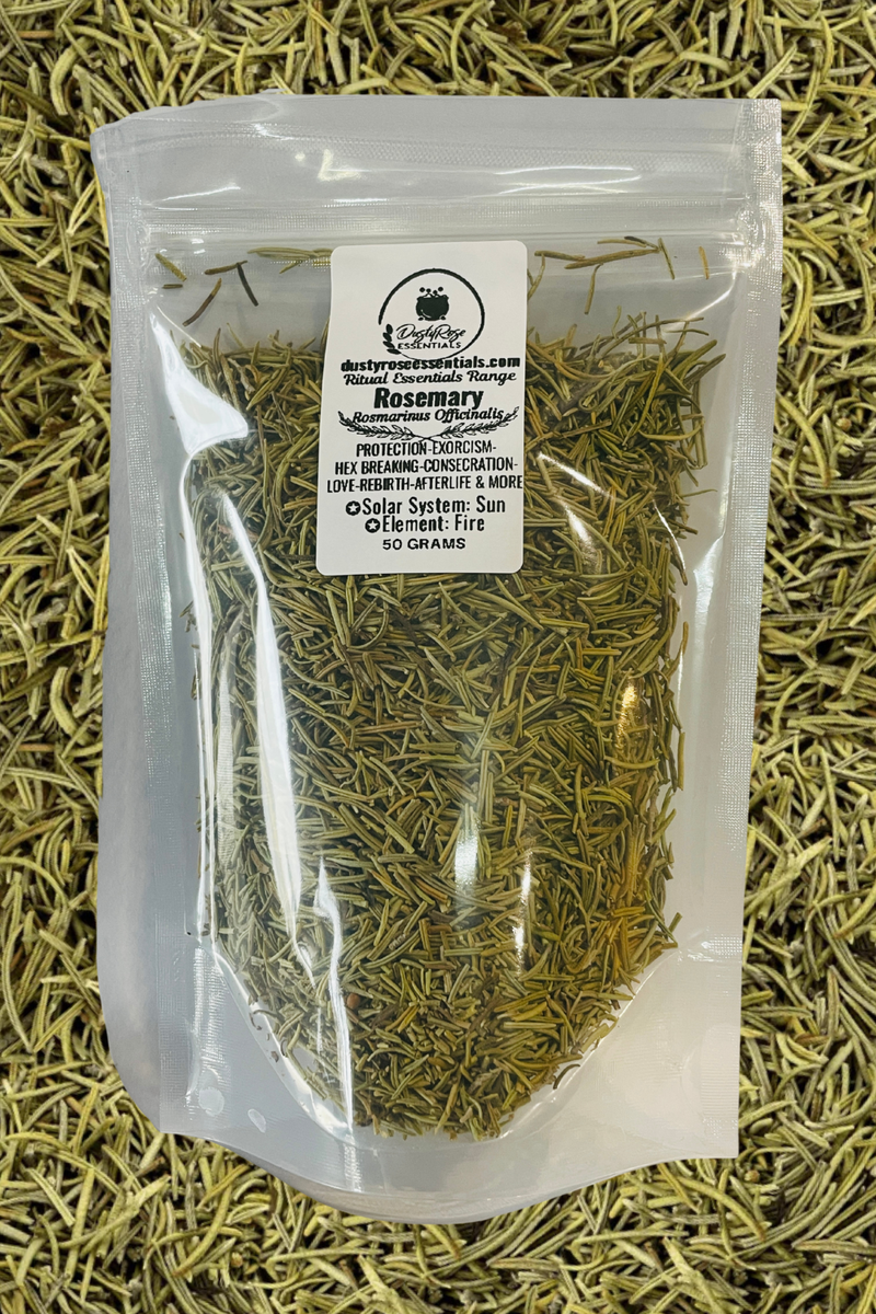 A clear plastic stand-up pouch filled with dried rosemary, placed on a bed of loose dried rosemary. The pouch has a white label with black text that reads 'Rosemary' and shows the brand Dusty Rose Essentials