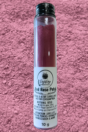 red rose petal powder from Dusty Rose Essentials in a glass jar with red rose petal powder in the background